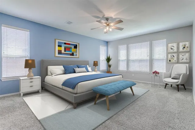 a spacious bedroom with a bed and a chandelier