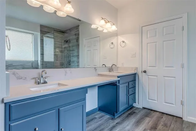 a bathroom with a sink vanity and a mirror