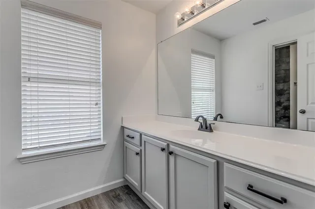 a bathroom with a sink and a mirror