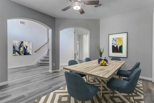 a view of a dining room with furniture and wooden floor