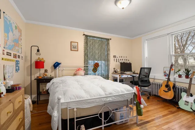 a bed room with furniture and a wooden floor