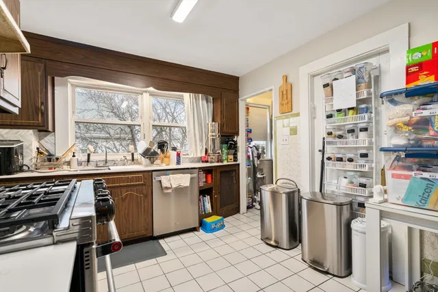 a kitchen with a sink refrigerator and window