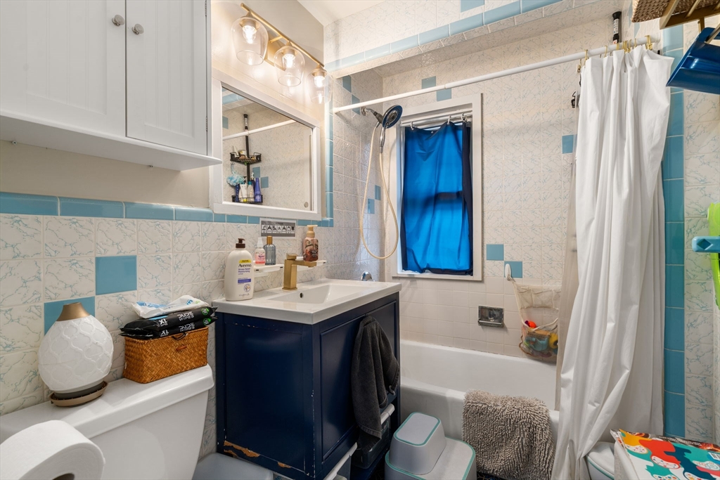 113-115 Nottinghill Road Boston, MA 02135 - Photo 6 of 12 a bathroom with a sink toilet and shower