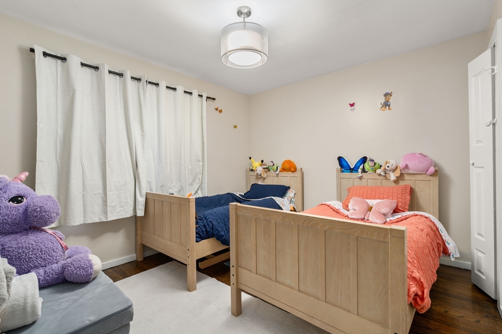 113-115 Nottinghill Road Boston, MA 02135 - Photo 7 of 12 a bedroom with a bed and a window