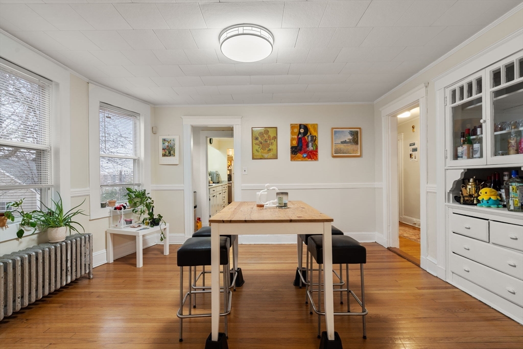 113-115 Nottinghill Road Boston, MA 02135 - Photo 8 of 12 a dining room with furniture and wooden floor