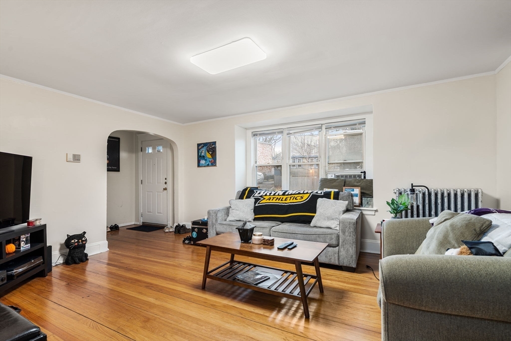 113-115 Nottinghill Road Boston, MA 02135 - Photo 9 of 12 a living room with furniture a flat screen tv and a window