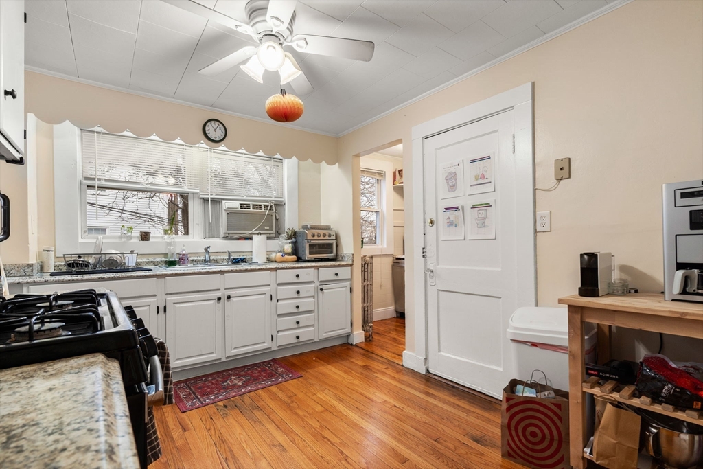 113-115 Nottinghill Road Boston, MA 02135 - Photo 10 of 12 a kitchen with stainless steel appliances granite countertop a stove and a sink