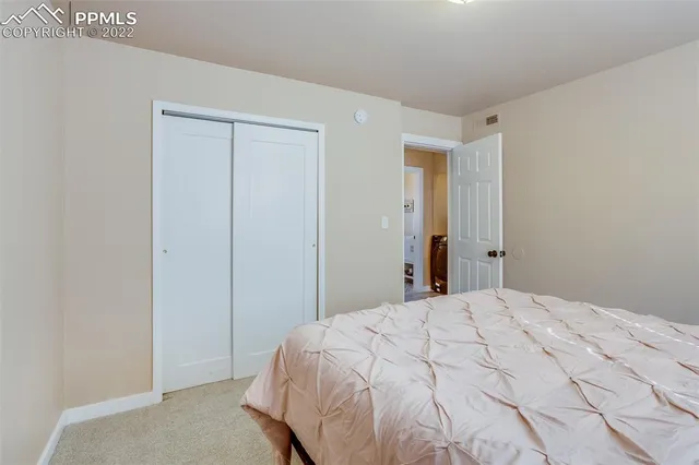 a bedroom with a bed and a mirror