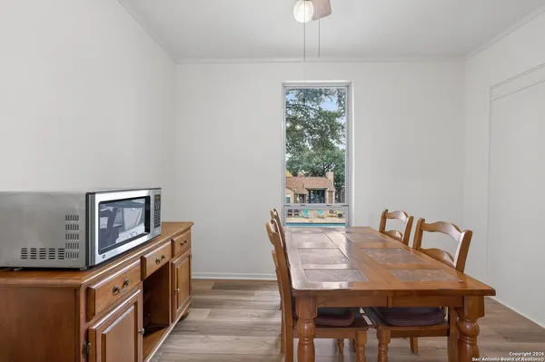 a view of a dining room with furniture and a window