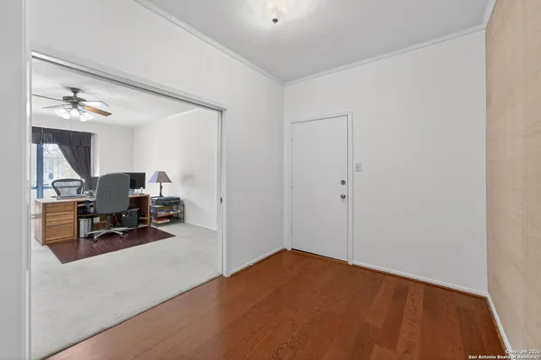a view of a room that has a bed and a chair in it