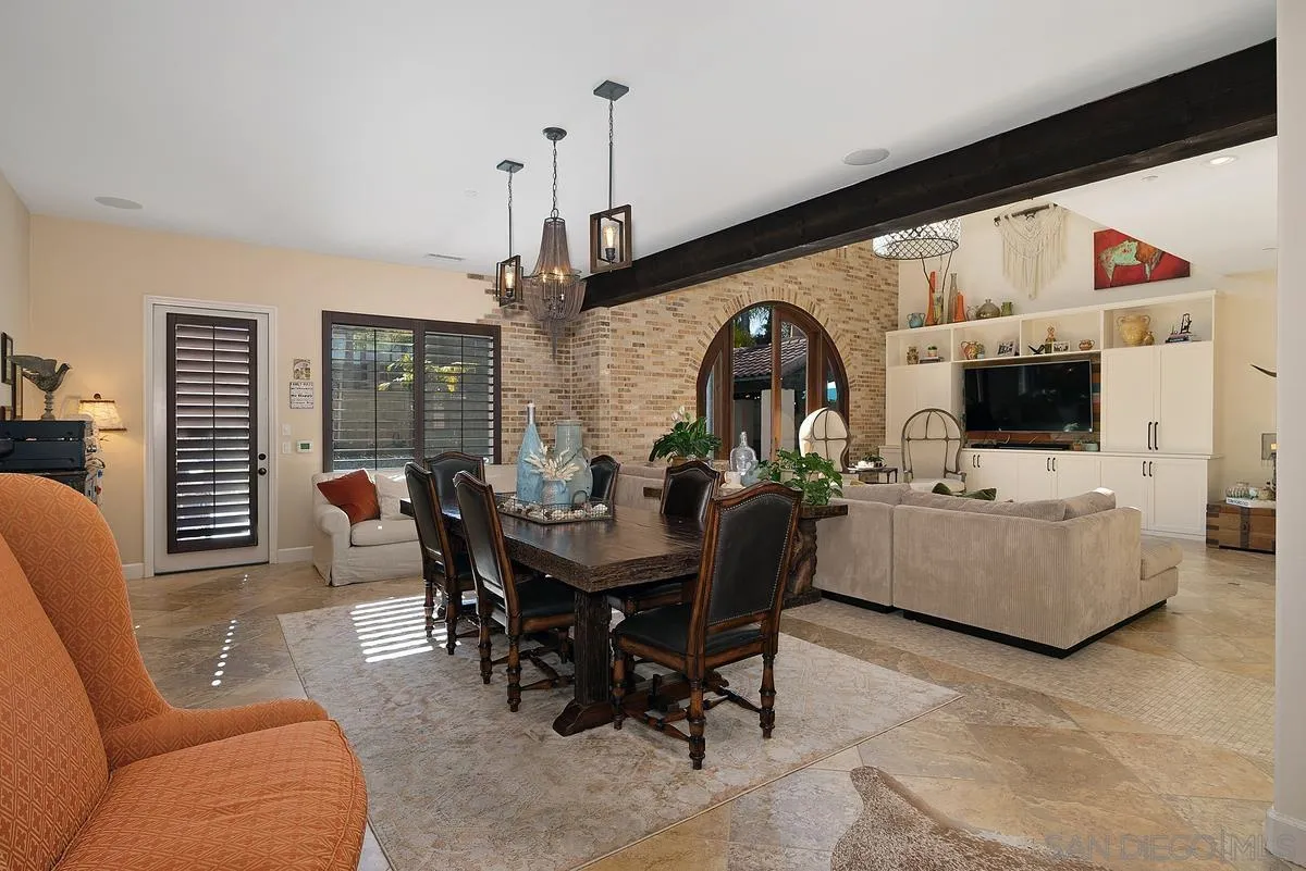14779 Rio Rancho San Diego, CA 92127 - Photo 13 of 35 a living room with furniture a flat screen tv and a large window