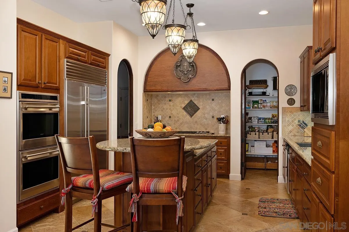 14779 Rio Rancho San Diego, CA 92127 - Photo 16 of 35 a view of a dining room with furniture and chandelier