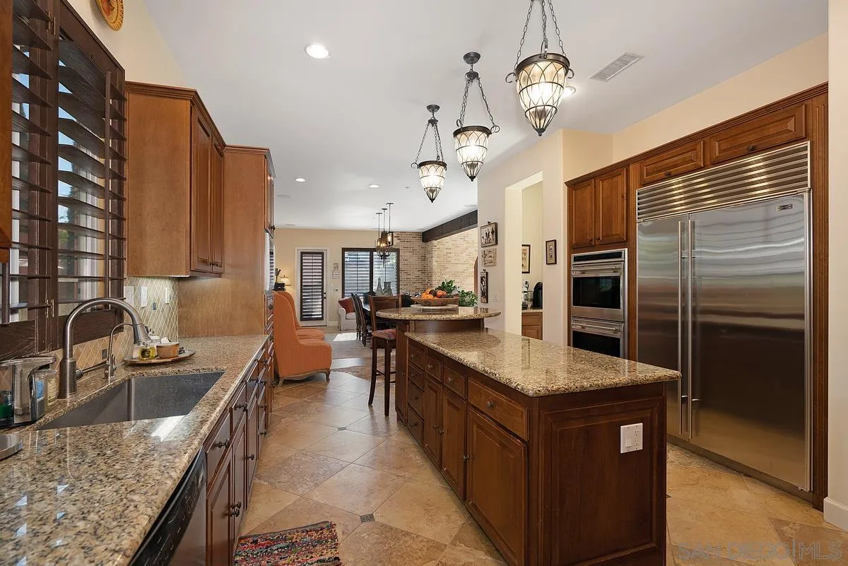 14779 Rio Rancho San Diego, CA 92127 - Photo 18 of 35 a kitchen with stainless steel appliances granite countertop a sink refrigerator and cabinets