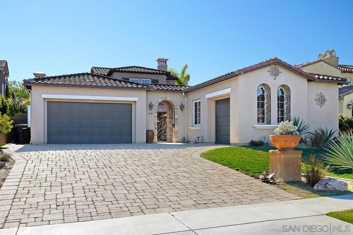 14779 Rio Rancho San Diego, CA 92127 - Photo 2 of 35 a front view of a house with a yard and garage