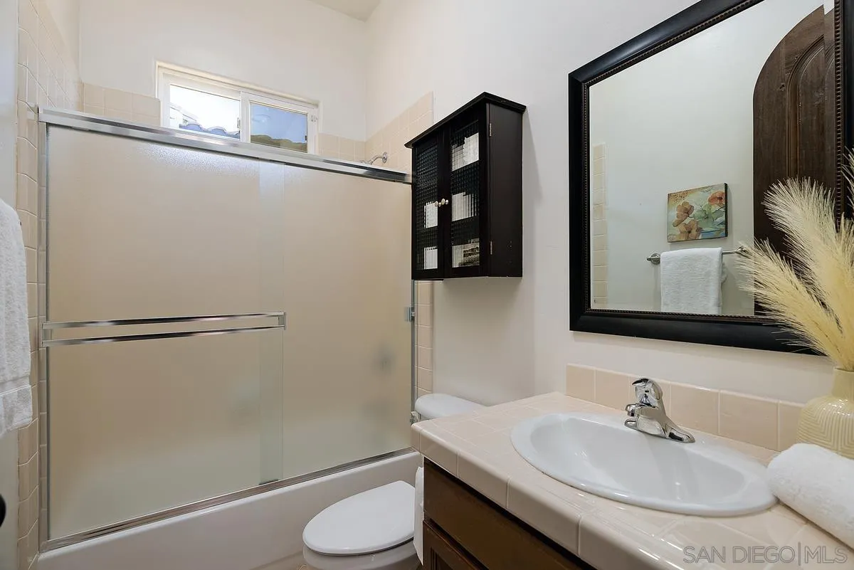 14779 Rio Rancho San Diego, CA 92127 - Photo 28 of 35 a bathroom with a sink and a mirror