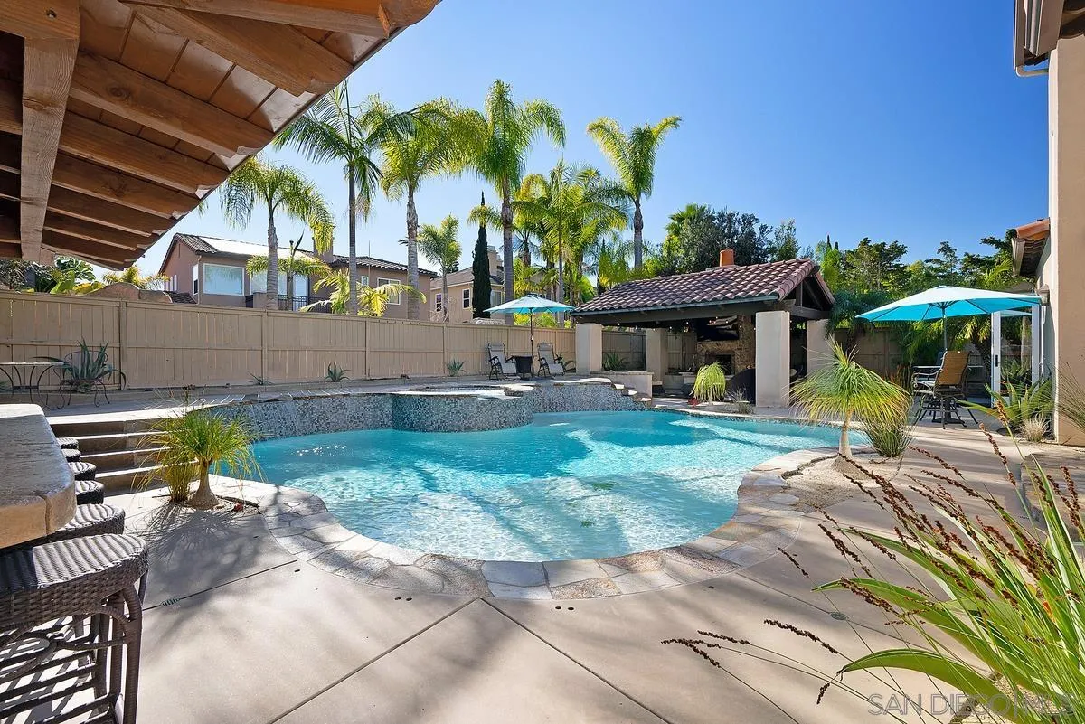 14779 Rio Rancho San Diego, CA 92127 - Photo 32 of 35 a view of a house with a swimming pool and sitting area