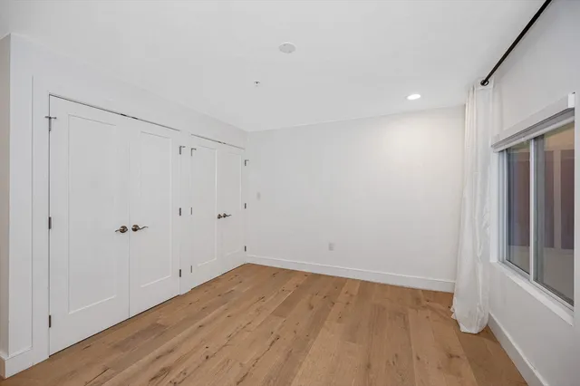 a view of room with wooden floor