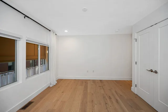 a view of a room with wooden floor and natural light