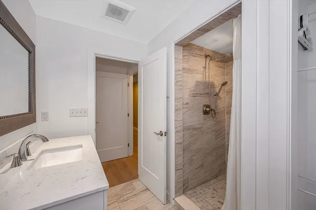 a bathroom with a sink and shower