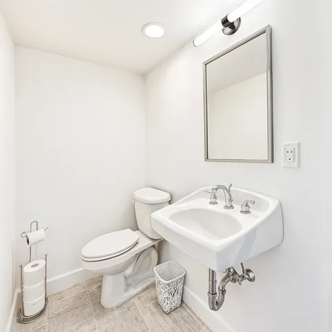 a white toilet sitting next to a bathroom sink