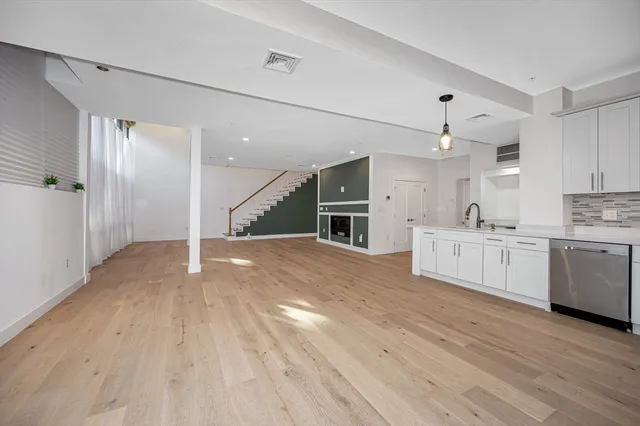 a view of kitchen with sink and cabinets