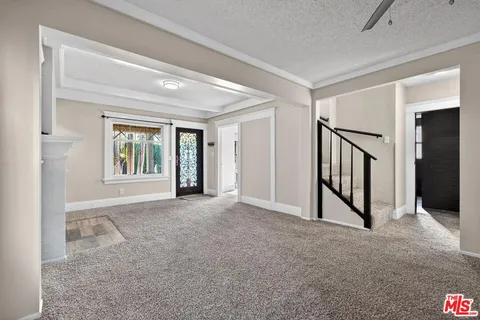 an empty room with windows and entryway