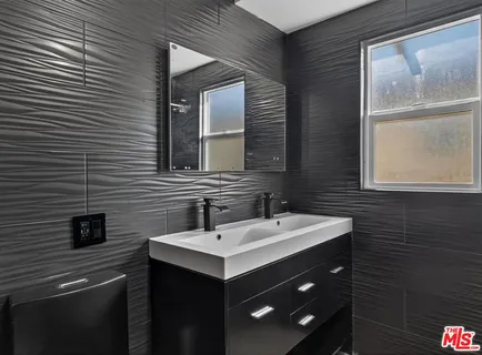a bathroom with a sink vanity and a mirror