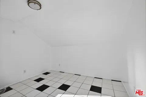 an empty room with windows and ceiling fan