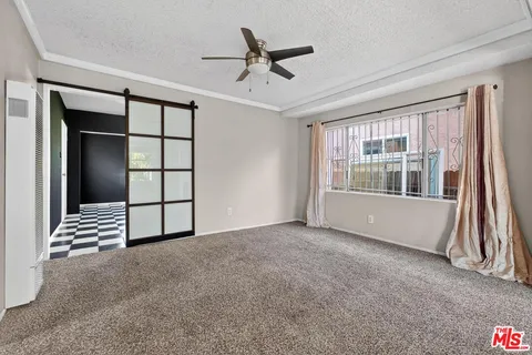a kitchen with granite countertop white cabinets and black appliances