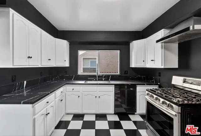 a kitchen with a refrigerator a sink and cabinets