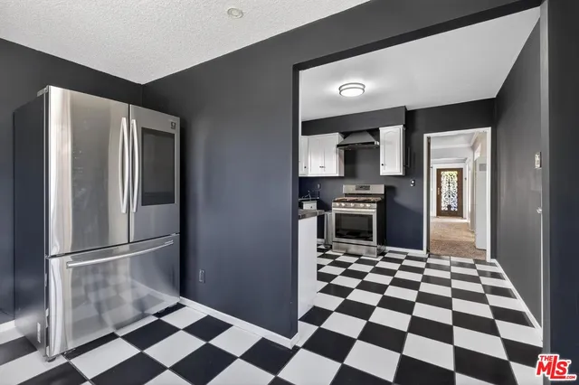 a view of a backyard with table and chairs and potted plants