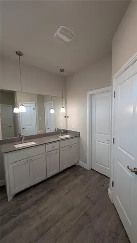 a bathroom with a granite countertop toilet and a sink