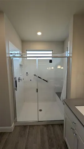 a bathroom with a sink a toilet a tub and shower