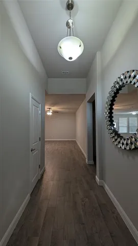 a view of a room with shelves and wooden floor