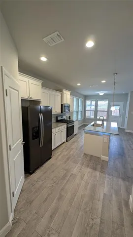 a view of a room with wooden floor and fireplace