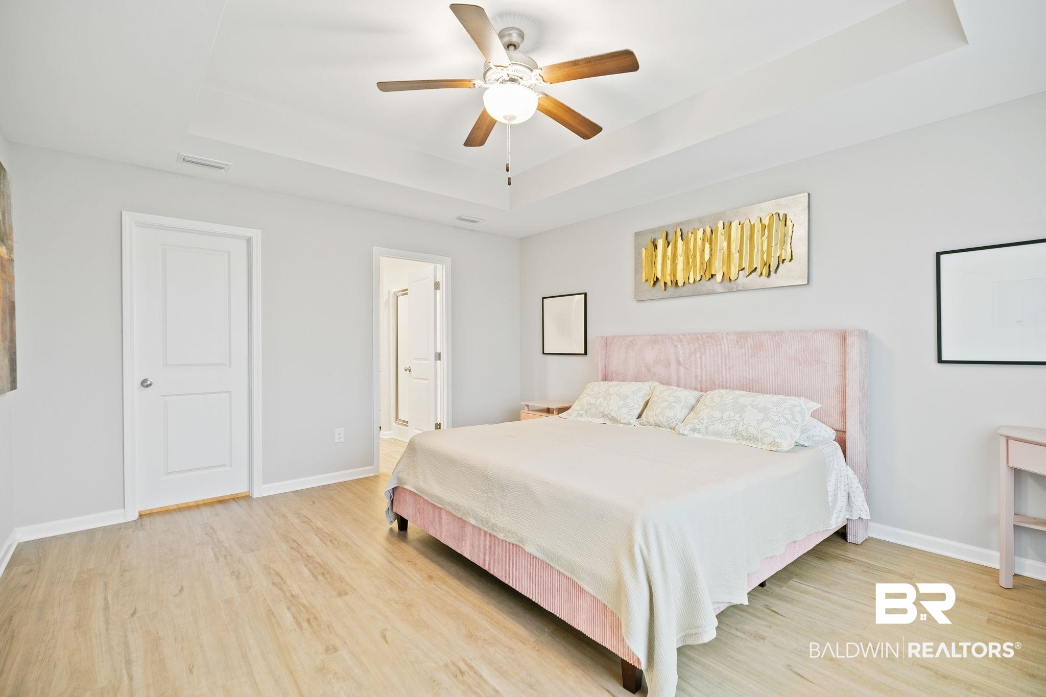 1271 Caper Avenue Foley, AL 36535 - Photo 16 of 29 Bedroom featuring ceiling fan, light wood-type flooring, and a tray ceiling