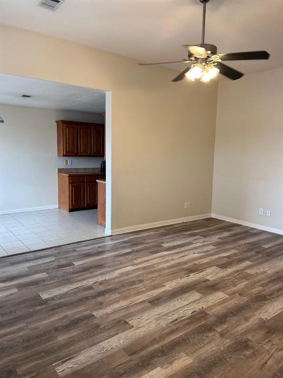 722 Rambling Court Granbury, TX 76049 - Photo 6 of 7 Unfurnished living room with a ceiling fan and light wood-type flooring