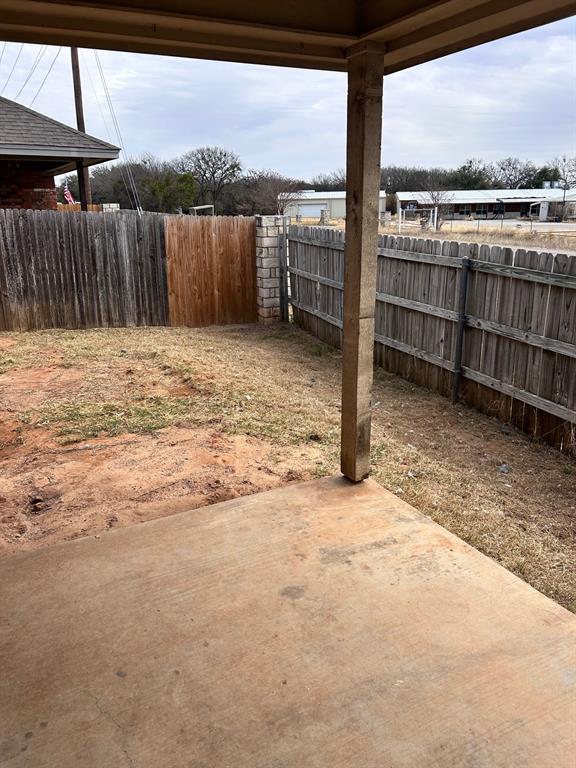 722 Rambling Court Granbury, TX 76049 - Photo 7 of 7 Fenced backyard with a patio