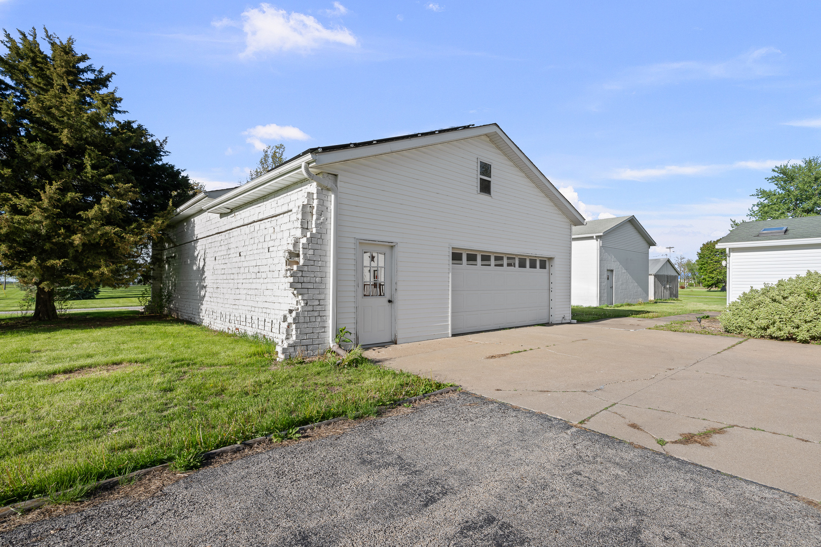 409 233rd Street Aledo, IL 61231 - Photo 11 of 30 a front view of a house with a yard and garage