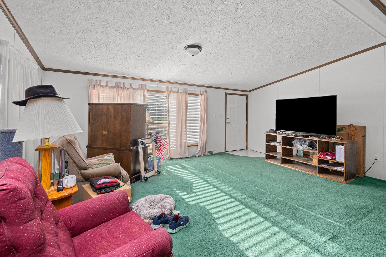 409 233rd Street Aledo, IL 61231 - Photo 16 of 30 a living room with furniture and a flat screen tv