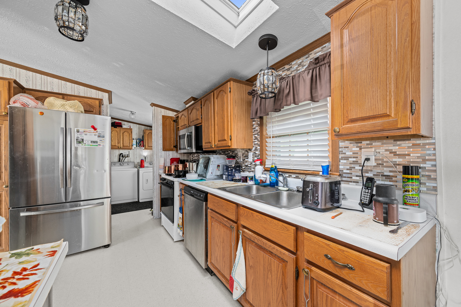 409 233rd Street Aledo, IL 61231 - Photo 23 of 30 a kitchen with stainless steel appliances granite countertop a refrigerator sink and cabinets