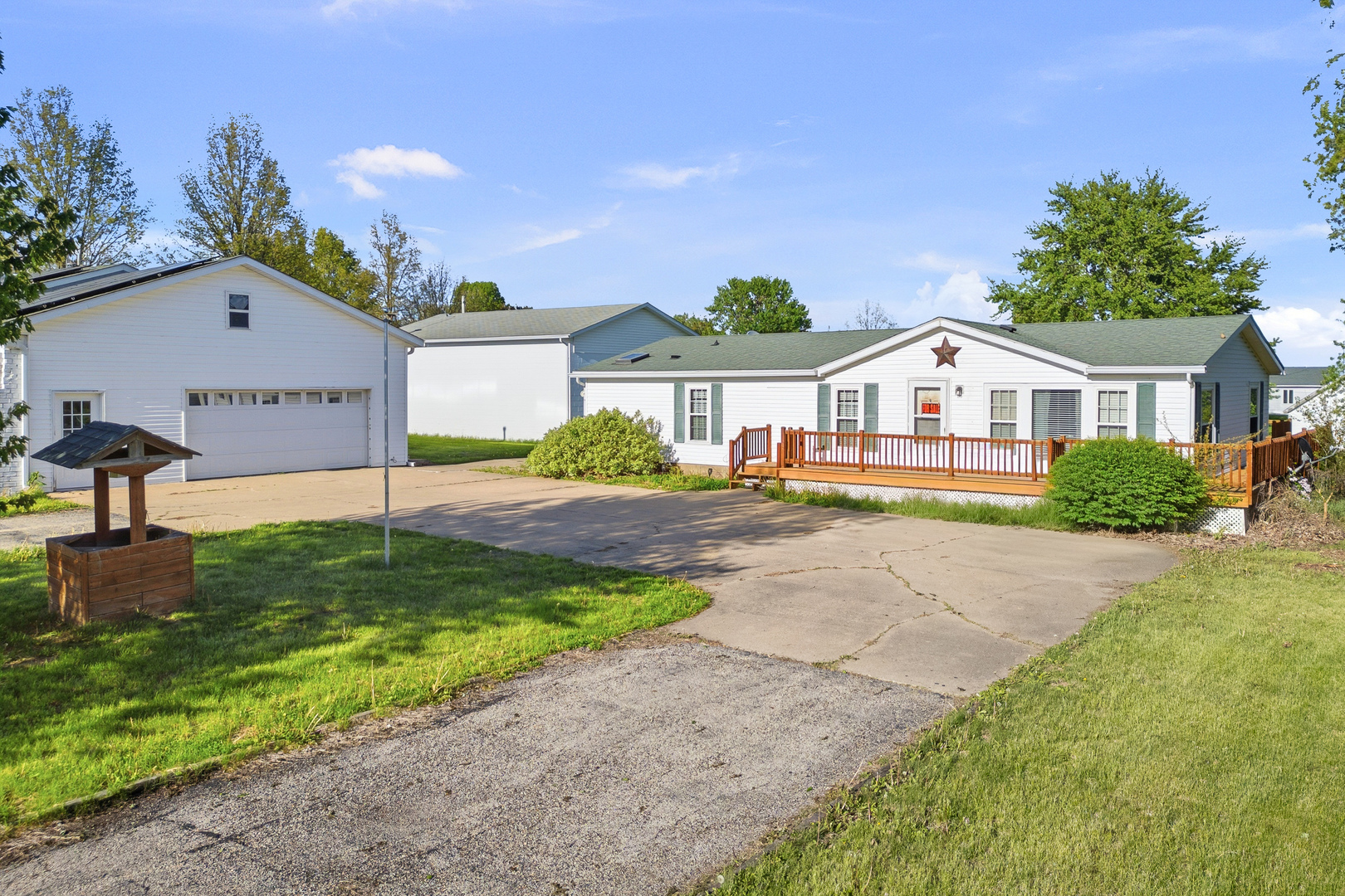 409 233rd Street Aledo, IL 61231 - Photo 3 of 30 a front view of a house with a garden and yard