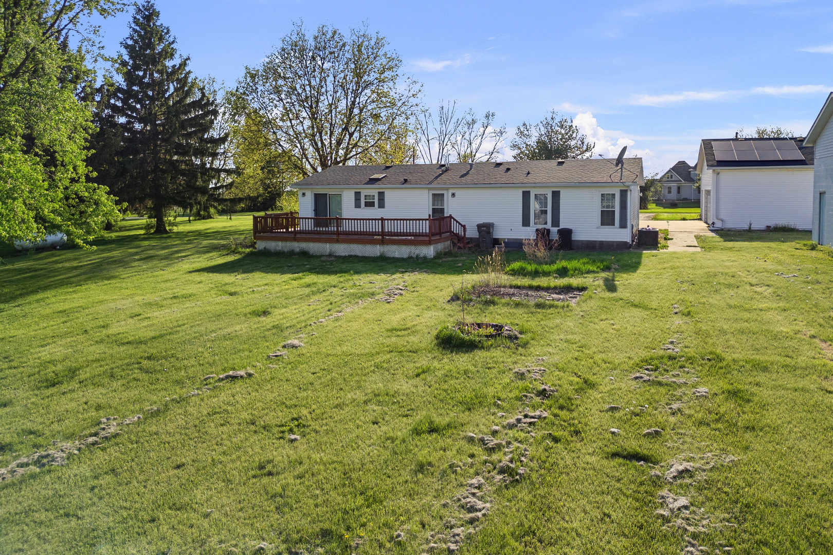 409 233rd Street Aledo, IL 61231 - Photo 7 of 30 a view of a house with a big yard potted plants and large tree