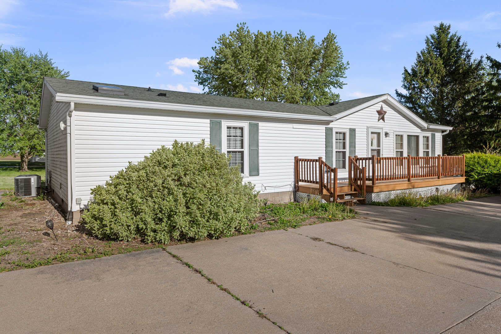 409 233rd Street Aledo, IL 61231 - Photo 10 of 30 a front view of a house with a garden and plants