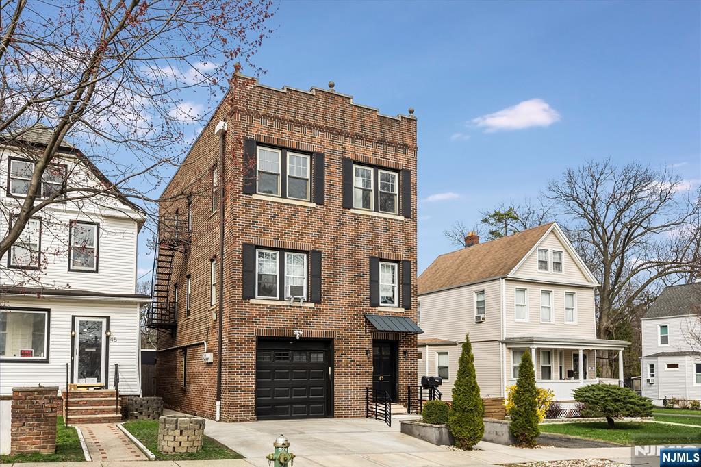 a front view of a residential apartment building with a yard