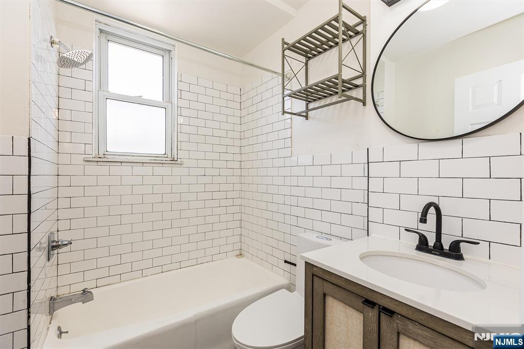 43 Pleasant Way Montclair, NJ 07042 - Photo 21 of 28 a bathroom with a sink a toilet and a bathtub