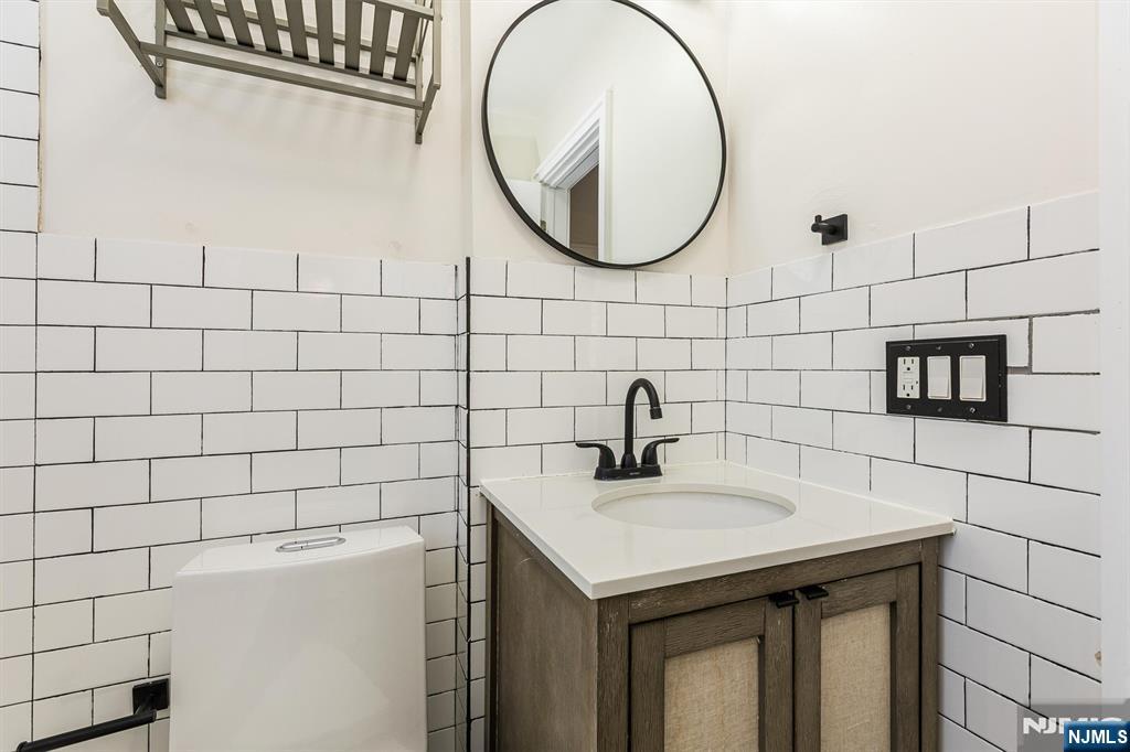 43 Pleasant Way Montclair, NJ 07042 - Photo 22 of 28 a bathroom with a sink and a mirror
