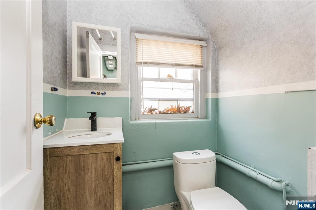 43 Pleasant Way Montclair, NJ 07042 - Photo 27 of 28 a bathroom with a sink a toilet and a window