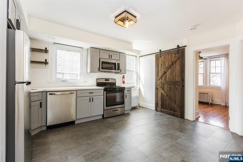43 Pleasant Way Montclair, NJ 07042 - Photo 5 of 28 a kitchen with a refrigerator and a stove