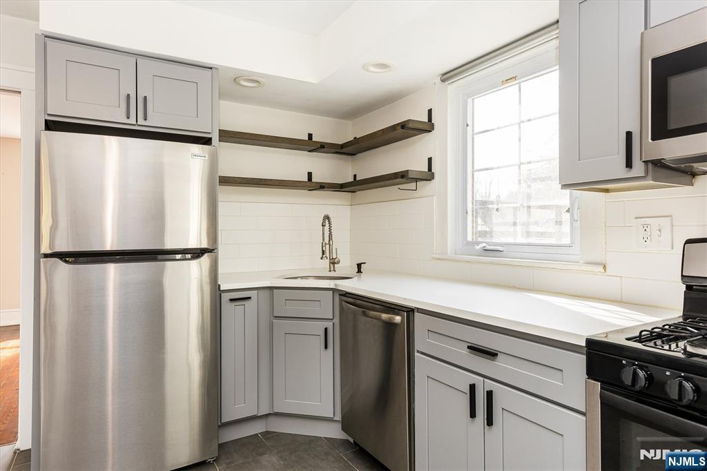 43 Pleasant Way Montclair, NJ 07042 - Photo 7 of 28 a kitchen with stainless steel appliances granite countertop a refrigerator and a sink
